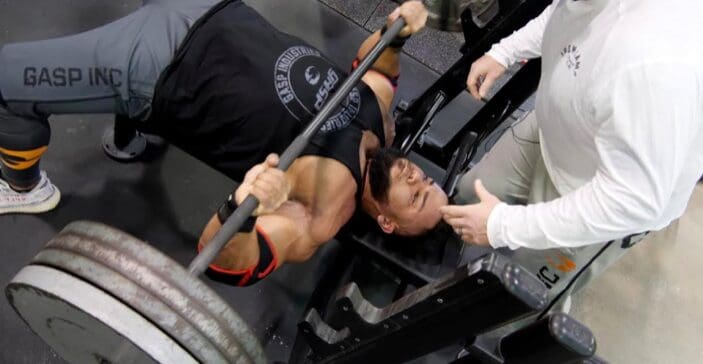 Muscular man doing bench presses