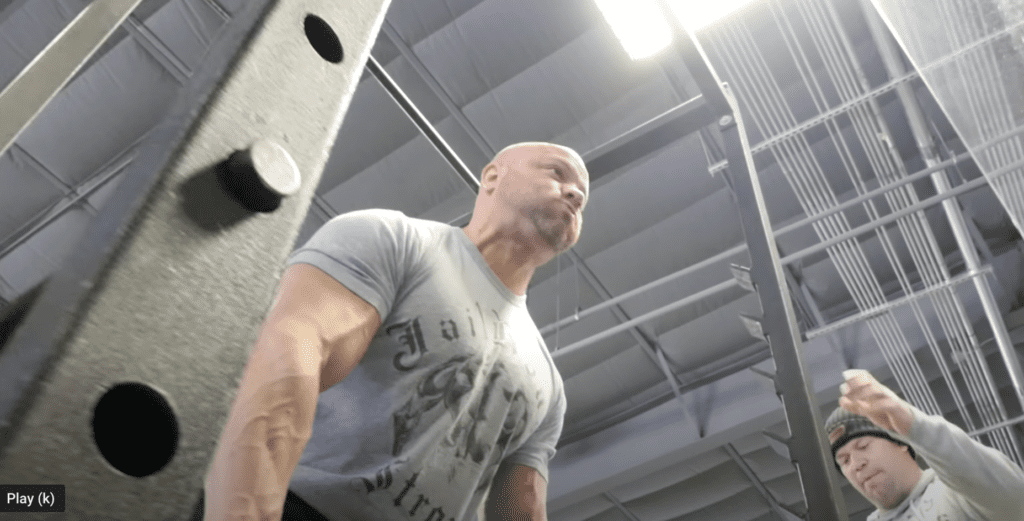A bald man working out